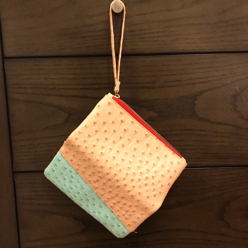 Pink and blue wallet and purse with polka dots.